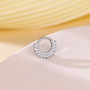Macro view of silver hinged clicker ring with double-layered cubic zirconia micro-paving