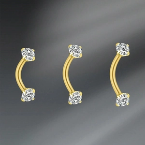 Detail of 16G curved eyebrow rings in gold finish with brilliant round-cut zircon stones