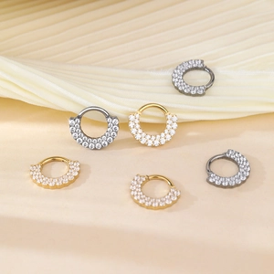 Detail view of 16G septum clickers with double row zircons in gold, silver, and black finish