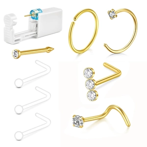 Detail van 7-delige gouden piercingkit met naalden en zirkonia neussieraden