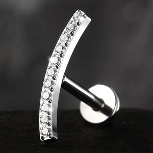 Macro view of curved G23 titanium labret stud with nine sparkling cubic zirconia stones