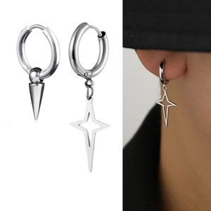 Macro detail of asymmetric stainless steel hoop earrings with spike and star pendants