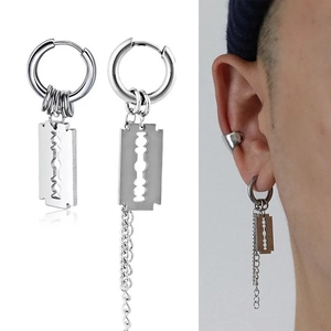 Detail view of asymmetric punk razor blade earrings with long metal chain tassels in silver