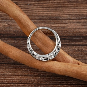 16G titanium nose hoop clicker with unique hammered texture on a rustic wood background