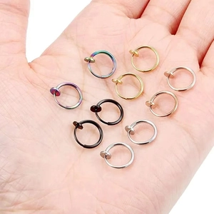 Set of 10 multicolor stainless steel spring clip earrings on palm for size comparison