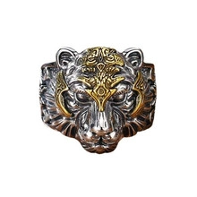 Detailed close-up of a tiger head ring in silver and gold-tone stainless steel