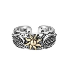 Detailed macro view of vintage stainless steel ring with sun pattern and trust engraving