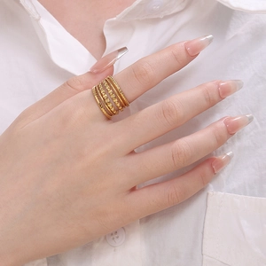 Minimalist gold stacked ring set with twisted rope and smooth band on finger
