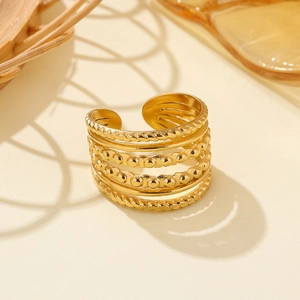 Minimalist layered gold stainless steel ring featuring braided textures and bead accents