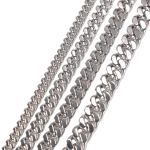 Macro detail showing four different widths of polished stainless steel Cuban link chains