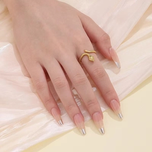 Adjustable gold snake ring in titanium steel with detailed spiral texture on model's hand