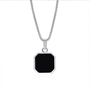 Detail view of square stainless steel pendant with black drip oil on silver box chain