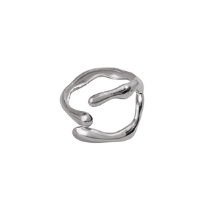Detailed macro view of an irregular silver stainless steel ring with liquid lava texture