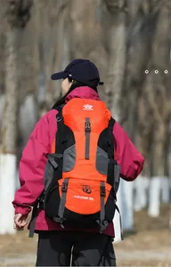 Detailed outdoor view of a 60L orange hiking backpack with multiple storage compartments