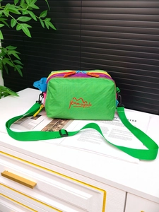 Macro shot of colorful color-block nylon crossbody bag with Kamapolo logo and textures