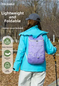 Outdoor view of a lightweight purple foldable backpack for hiking with bungee cord detail