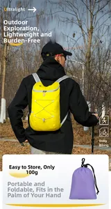 Macro shot of a yellow ultralight foldable hiking backpack weighing only 100g in forest
