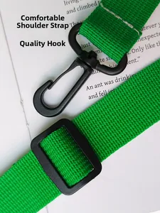 Detail of bright green woven strap with black metal swivel lobster clasp and adjuster