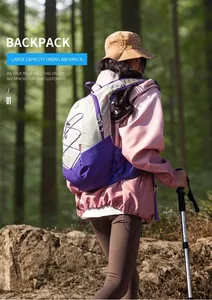 Outdoor enthusiast hiking in forest with 18L purple and grey lightweight backpack