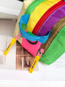 Detail of wide sky blue woven handle with D-ring and colorful zipper on waterproof bag