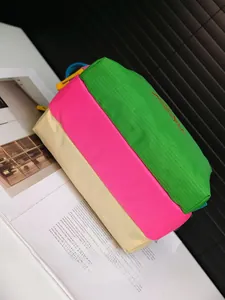 Detail of a color-block waterproof nylon shoulder bag with a sturdy bottom design
