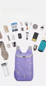 Purple waterproof folding backpack shown with outdoor gear highlighting large capacity
