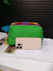 Detailed comparison of the multi-pocket nylon crossbody bag with a smartphone for scale