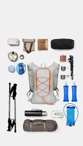 Flat lay of outdoor cycling hydration vest with camping gear and hiking accessories