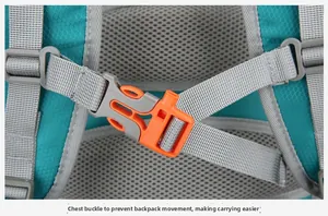 Detail of the teal nylon backpack chest buckle with integrated emergency whistle feature
