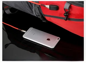 Detail view of the outdoor backpack side showing integrated USB charging port with cable