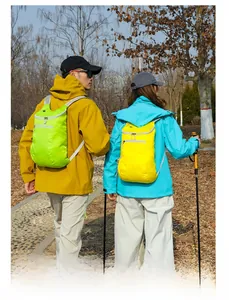 Outdoor foldable backpack close-up in vibrant green and yellow colors for hiking