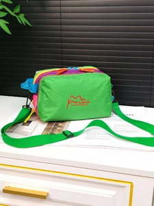 Close-up of multicolor outdoor crossbody bag with vibrant stitching and durable strap