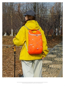 Outdoor waterproof orange foldable hiking backpack with elastic cord and trekking poles