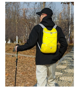 Detailed view of lightweight yellow waterproof hiking backpack with elastic cord system