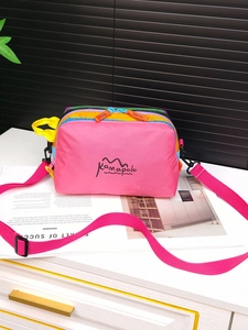 Macro detail of multi-color nylon sling bag with waterproof zippers and logo