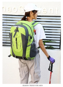 Side view of professional green outdoor hiking backpack with breathable side mesh pockets