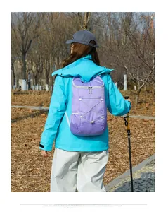 Close-up of purple outdoor sports backpack featuring elastic cords and safety reflective details