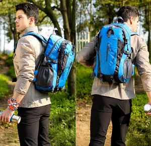 Outdoor hiking backpack in blue and grey nylon shown on a model in a forest