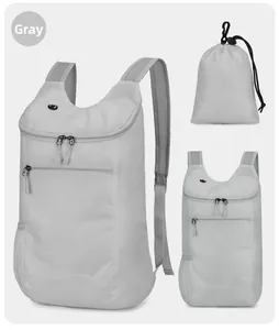 Detail view of foldable grey lightweight backpack with storage bag and water-resistant fabric