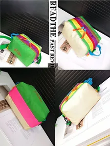 Detail view of water-repellent nylon crossbody bag with colorful patchwork and embroidery