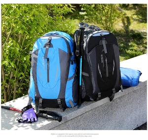 Outdoor hiking backpack detail with hiking poles, gloves and waterproof storage bag