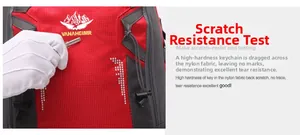 Macro shot showing scratch-resistant nylon fabric testing on a red hiking backpack
