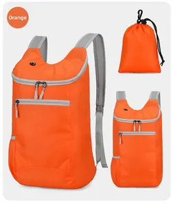 Macro detail of the orange water-resistant foldable backpack with matching storage pouch