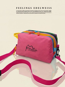 Detailed macro view of colorful multi-pocket waterproof nylon crossbody bag with pink strap