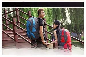 Detail of red and blue waterproof hiking backpacks with adjustable chest straps and buckles