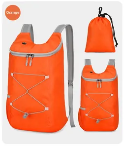 Detail of water-resistant orange hiking backpack with elastic cord and folding storage bag