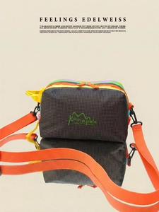 Detailed close-up of rainbow layered outdoor crossbody bag with orange strap and buckle
