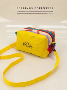 Detail of color-block waterproof crossbody bag with durable nylon strap and snap hooks