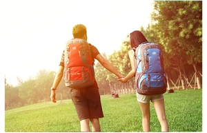 Outdoor 80L hiking backpacks in red and blue colors shown in a scenic mountain setting