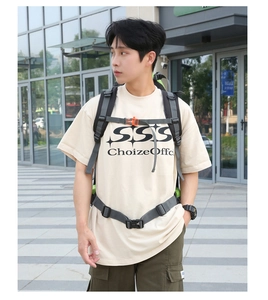 Close-up of hiking backpack with orange chest strap and ergonomic grey waist buckle